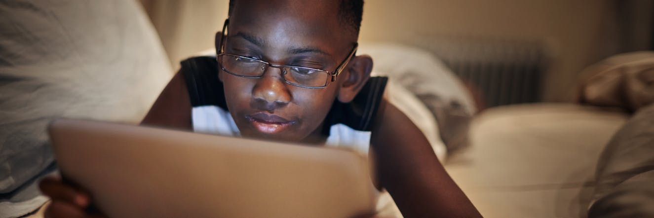 Child using a reading app on his tablet