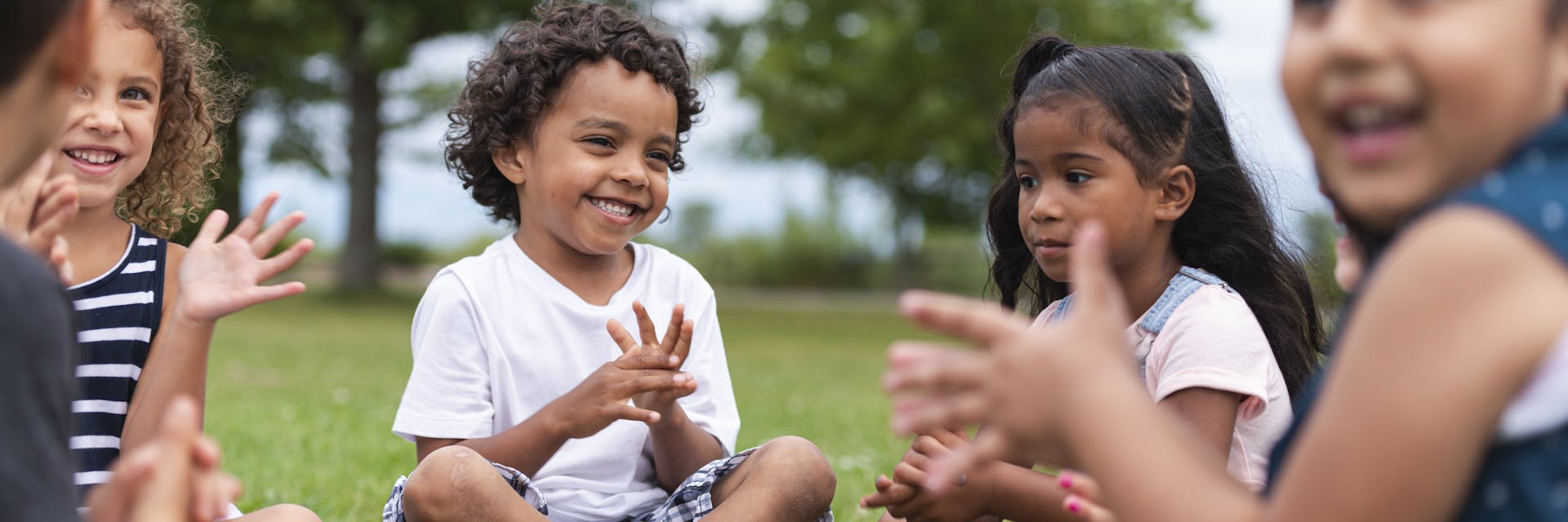 Group of kindergarten kids learning outside