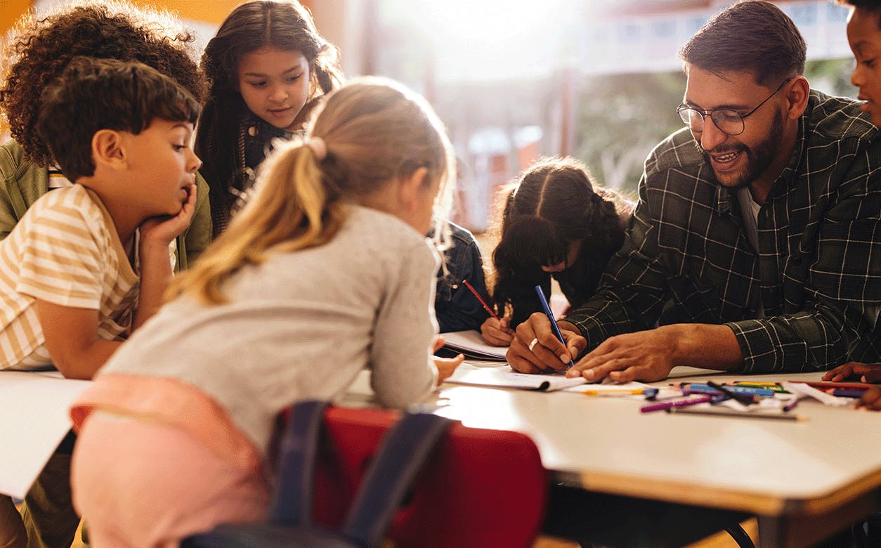 A diverse group of children and adults gathered around a table