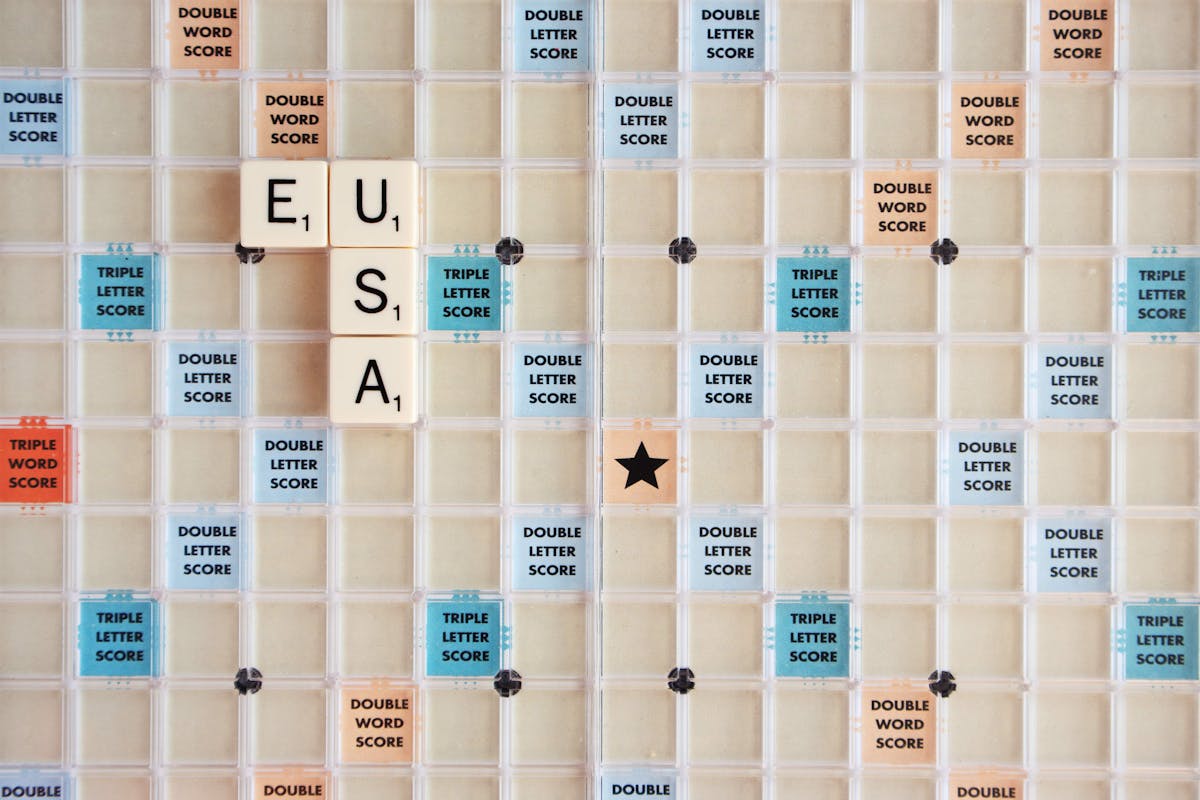 Image of a Scrabble board with the letters U, S, and A forming the word "USA" on it