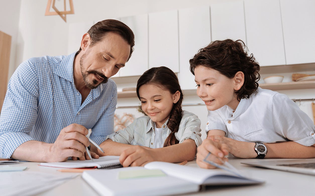 A dad collaborates with two children on a project