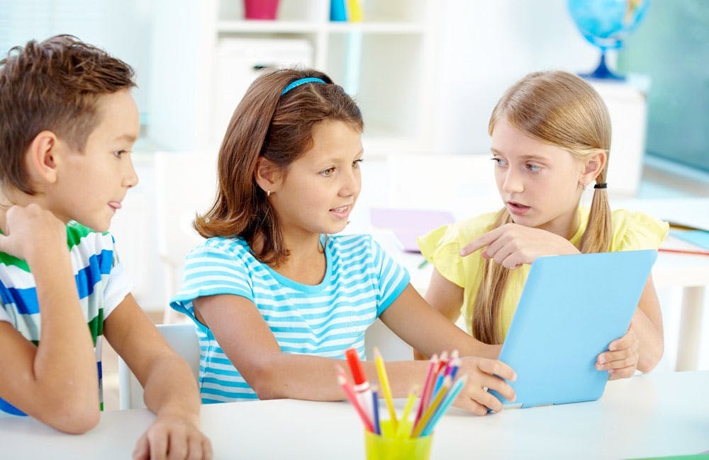 Children learning by playing games on an ipad