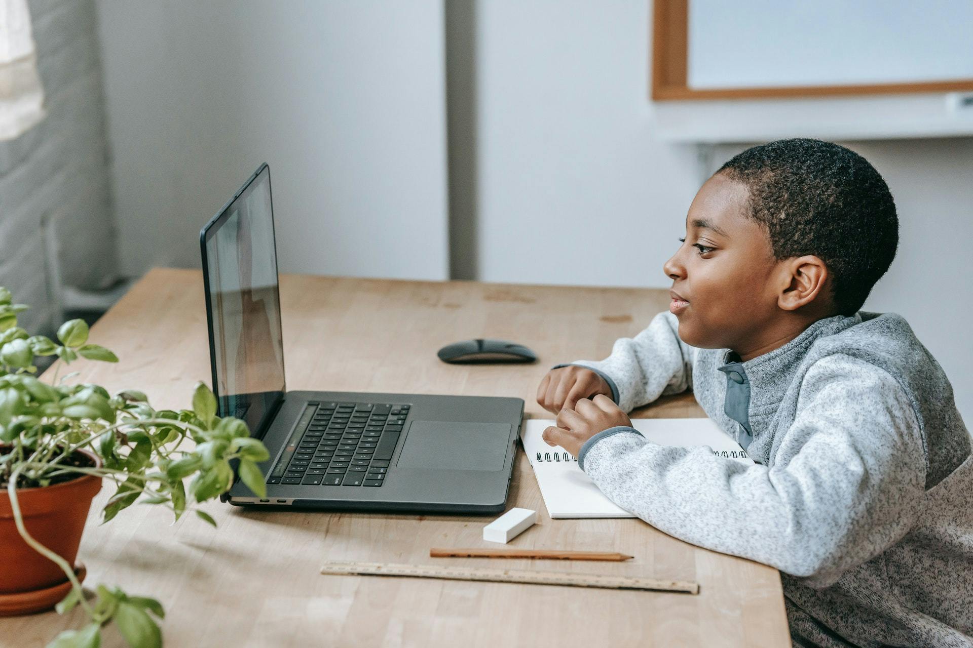 Child participates in a lesson at home through a virtual classroom.