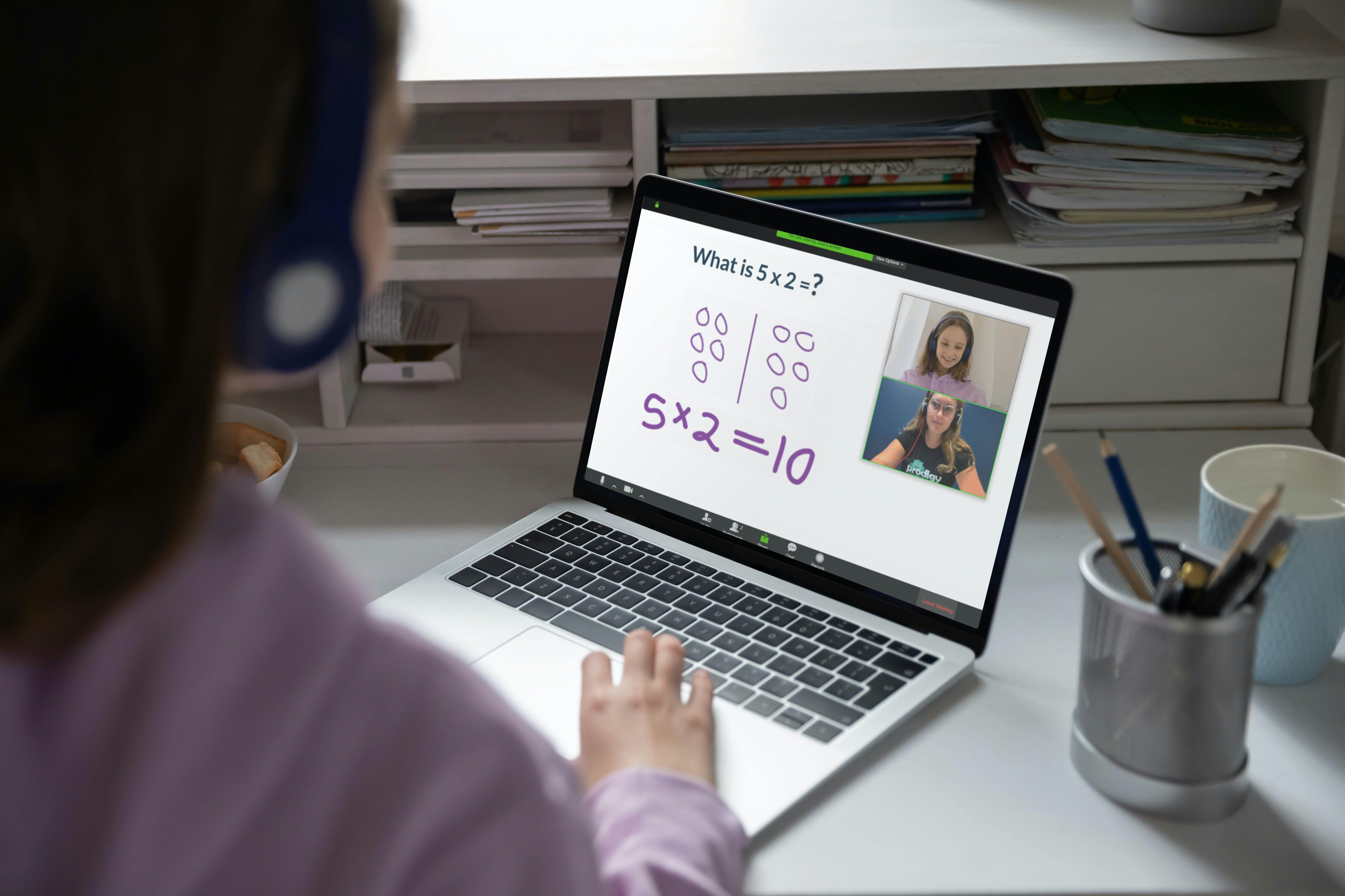 Child sitting at a laptop for their tutoring session.