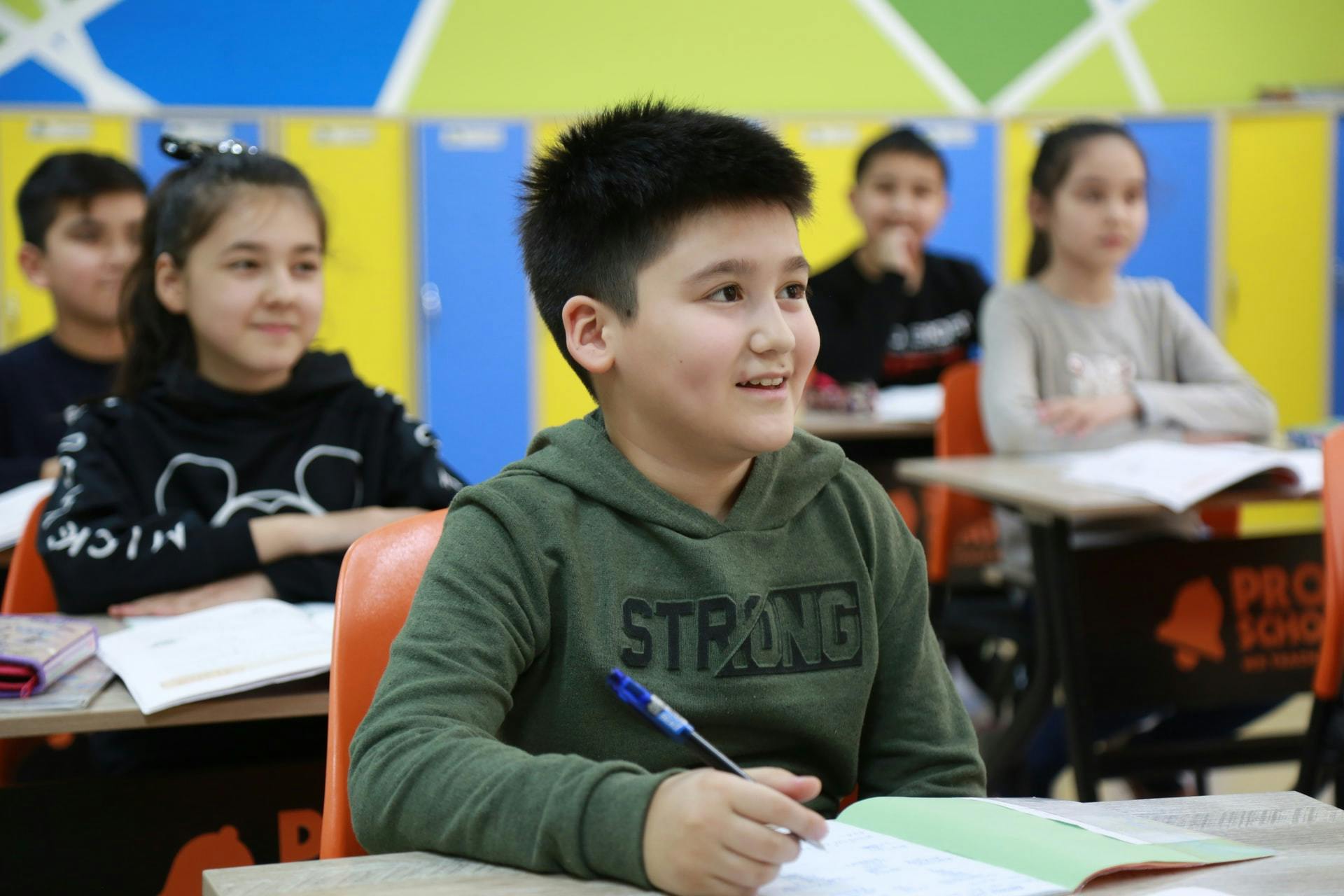 Boy writes in the classroom during a lesson aligned to Bloom's taxonomy.