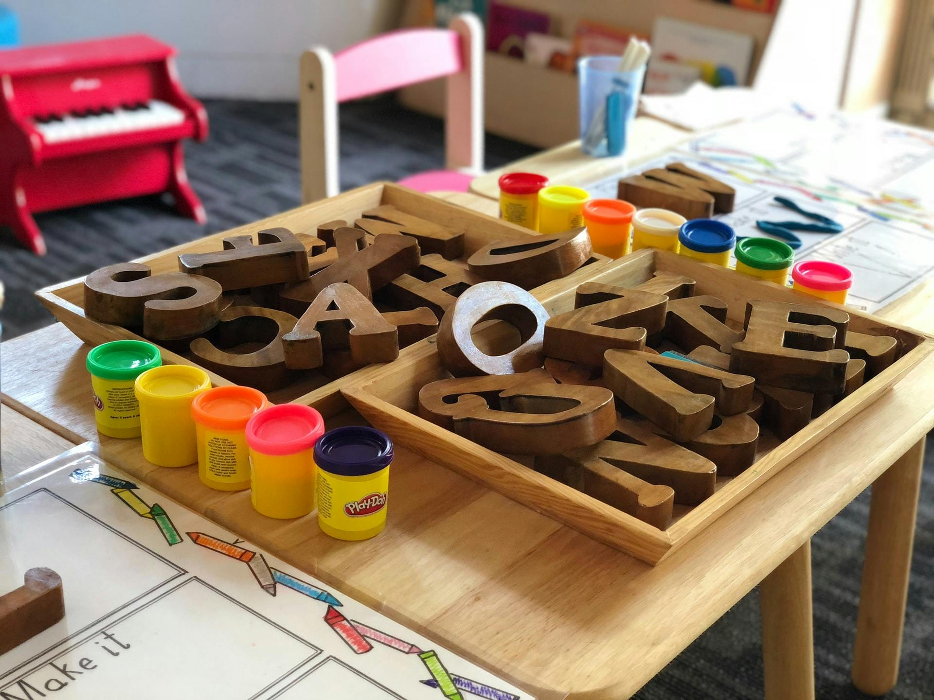 Wooden blocks and play-dough set out as part of a preschool lesson plan