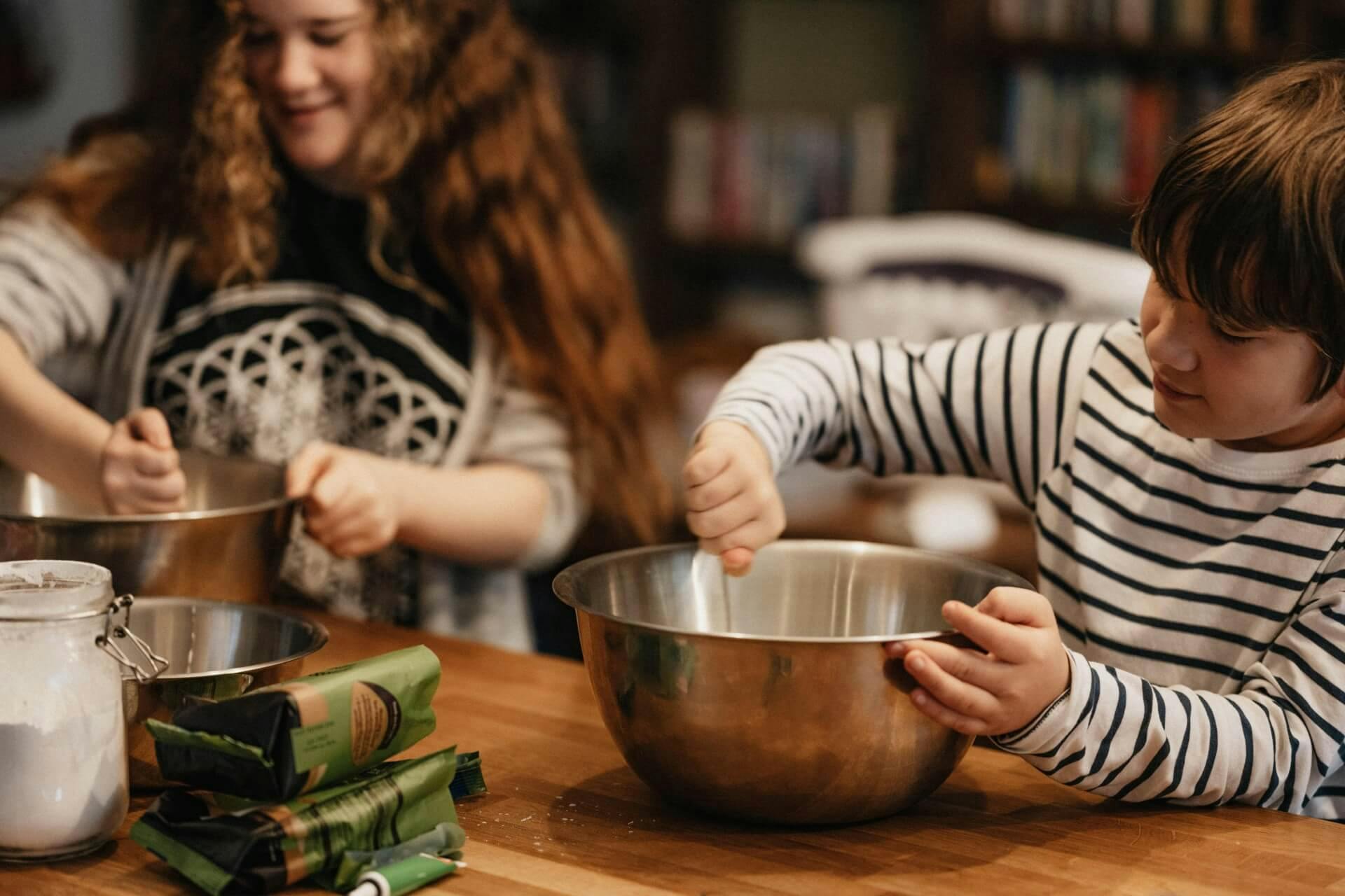 Siblings preparing a meal together in their kitchen.