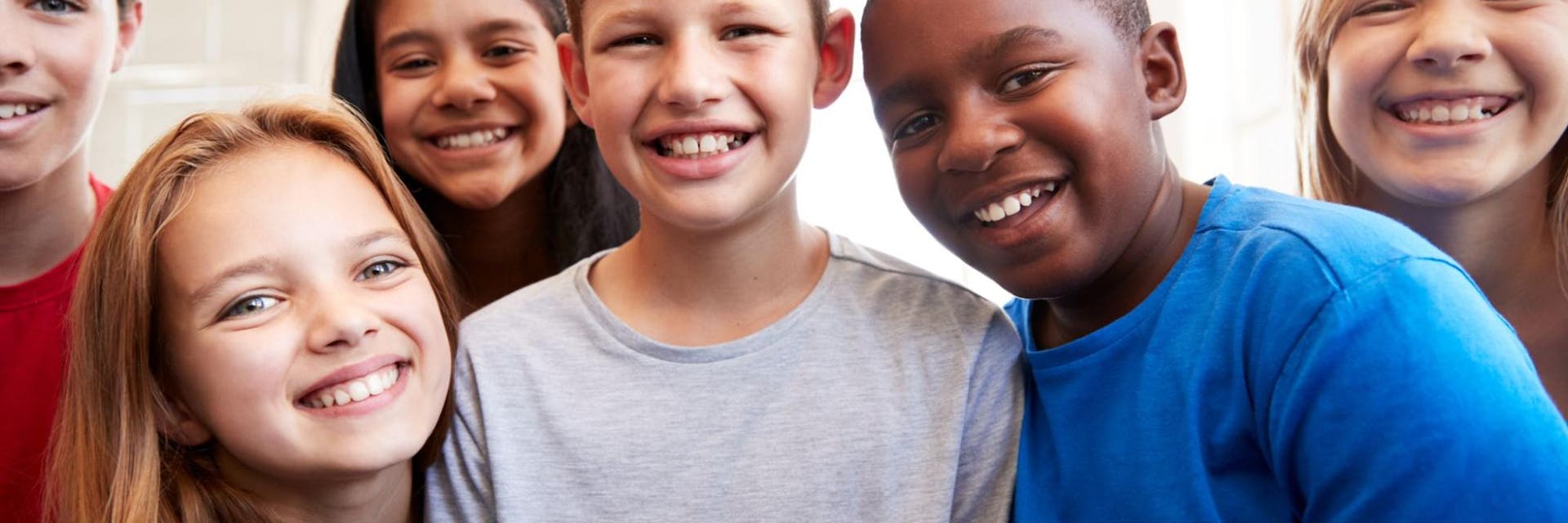 Group of students smile at the camera in a positive learning environment.