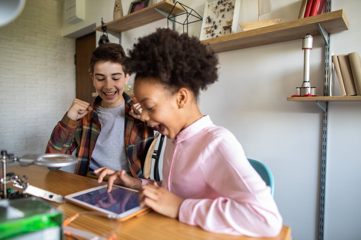 Excited kids playing Prodigy while virtual learning