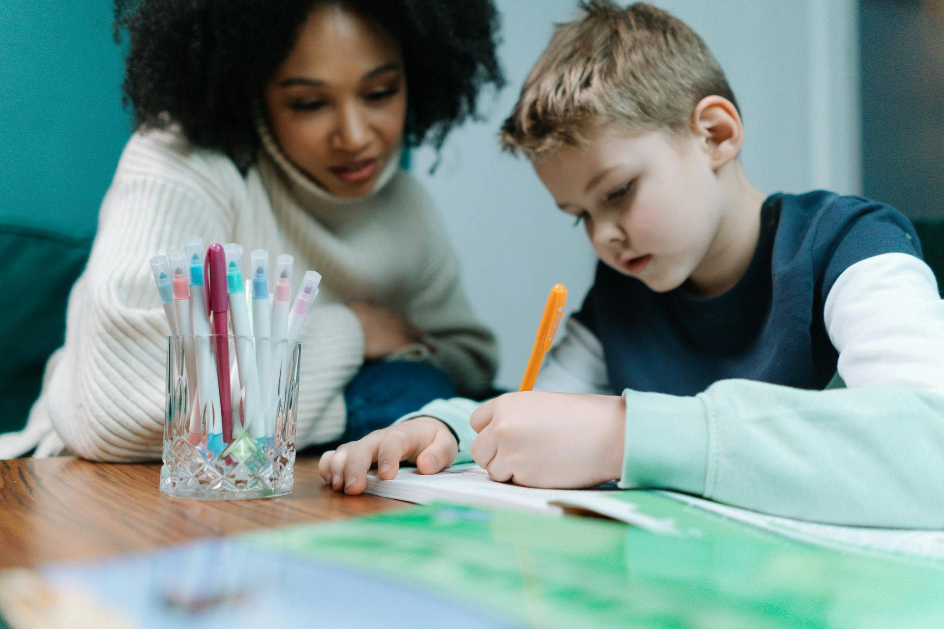 A teacher and student work together on vocabulary activities in the classroom.