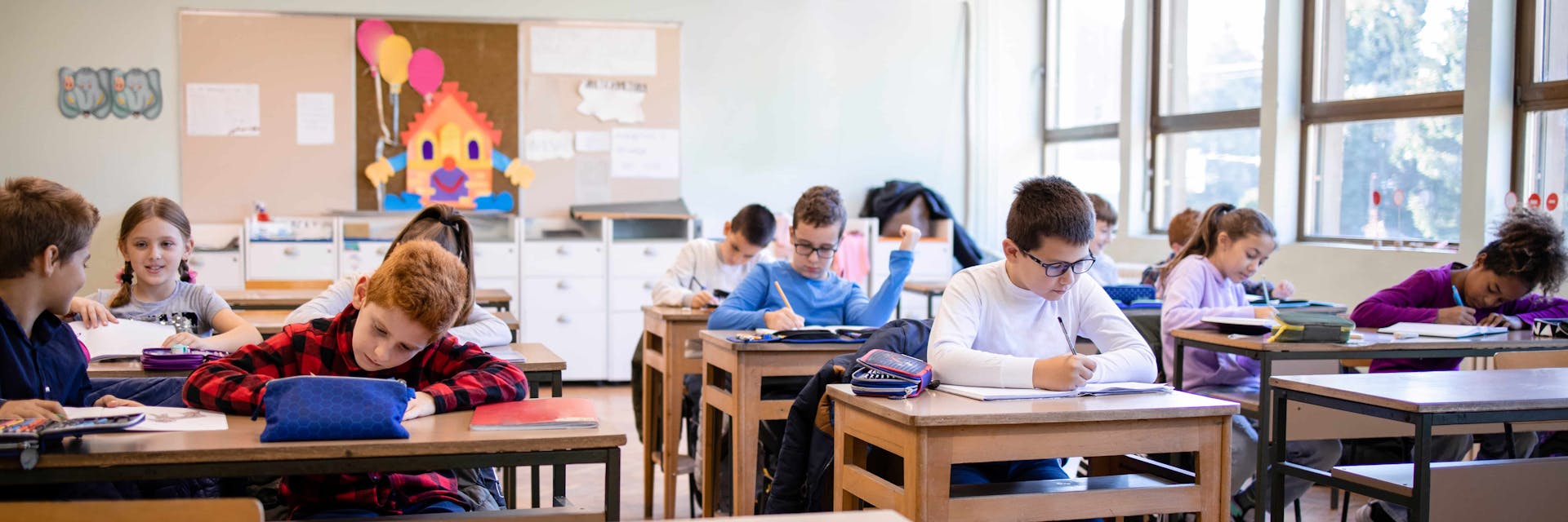 summative assessment activity Elementary students taking a summative assessment in a classroom.