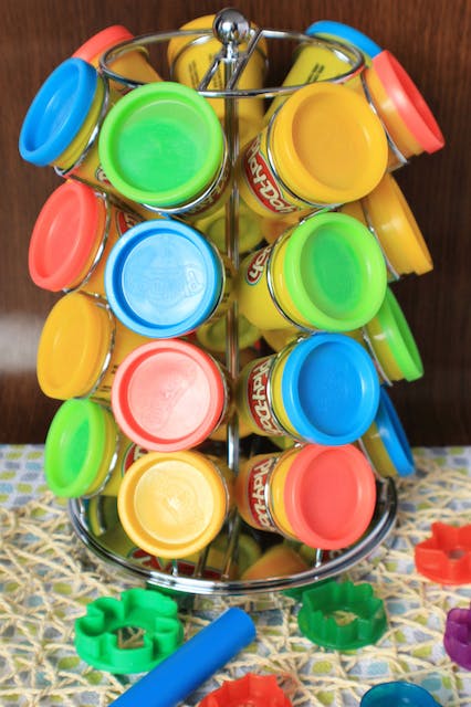 Coffee pod carousel holding tubs of play dough.