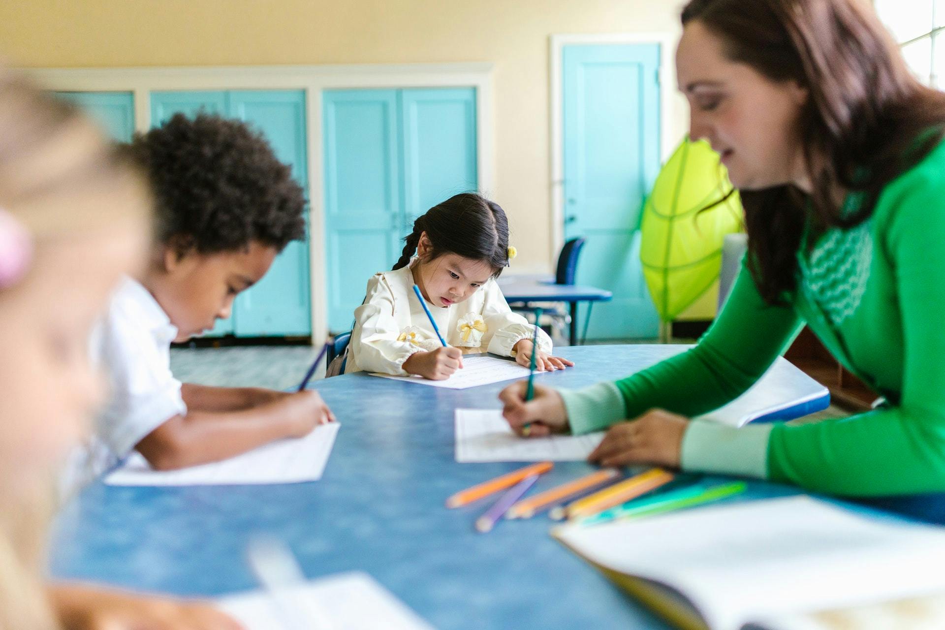 Teacher and students work on subtraction worksheets together.