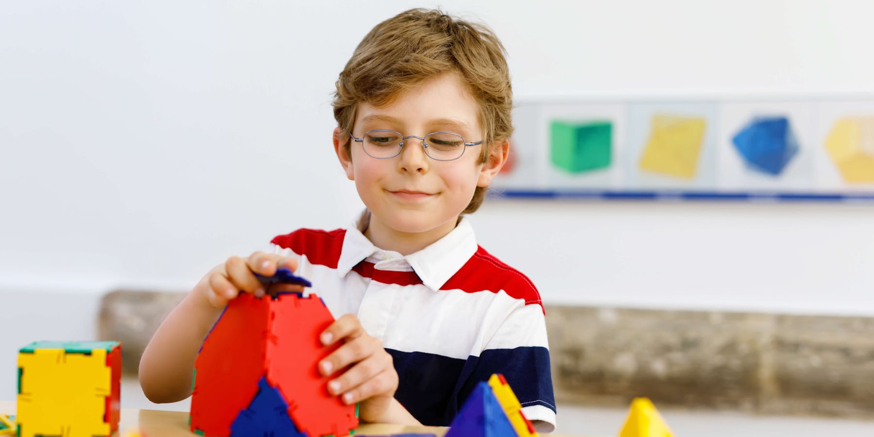 Student using pattern blocks in math class.