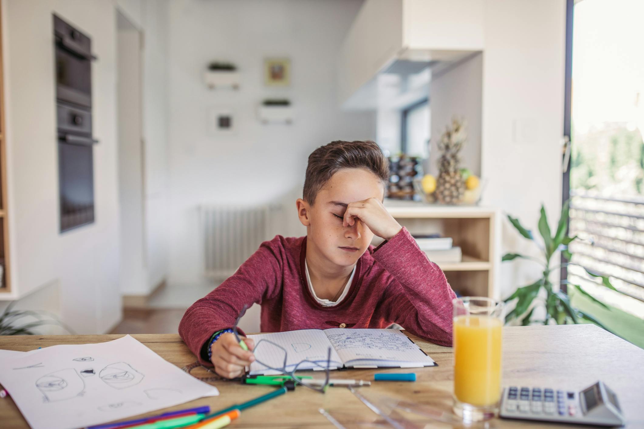 Frustrated child studying at his desk.