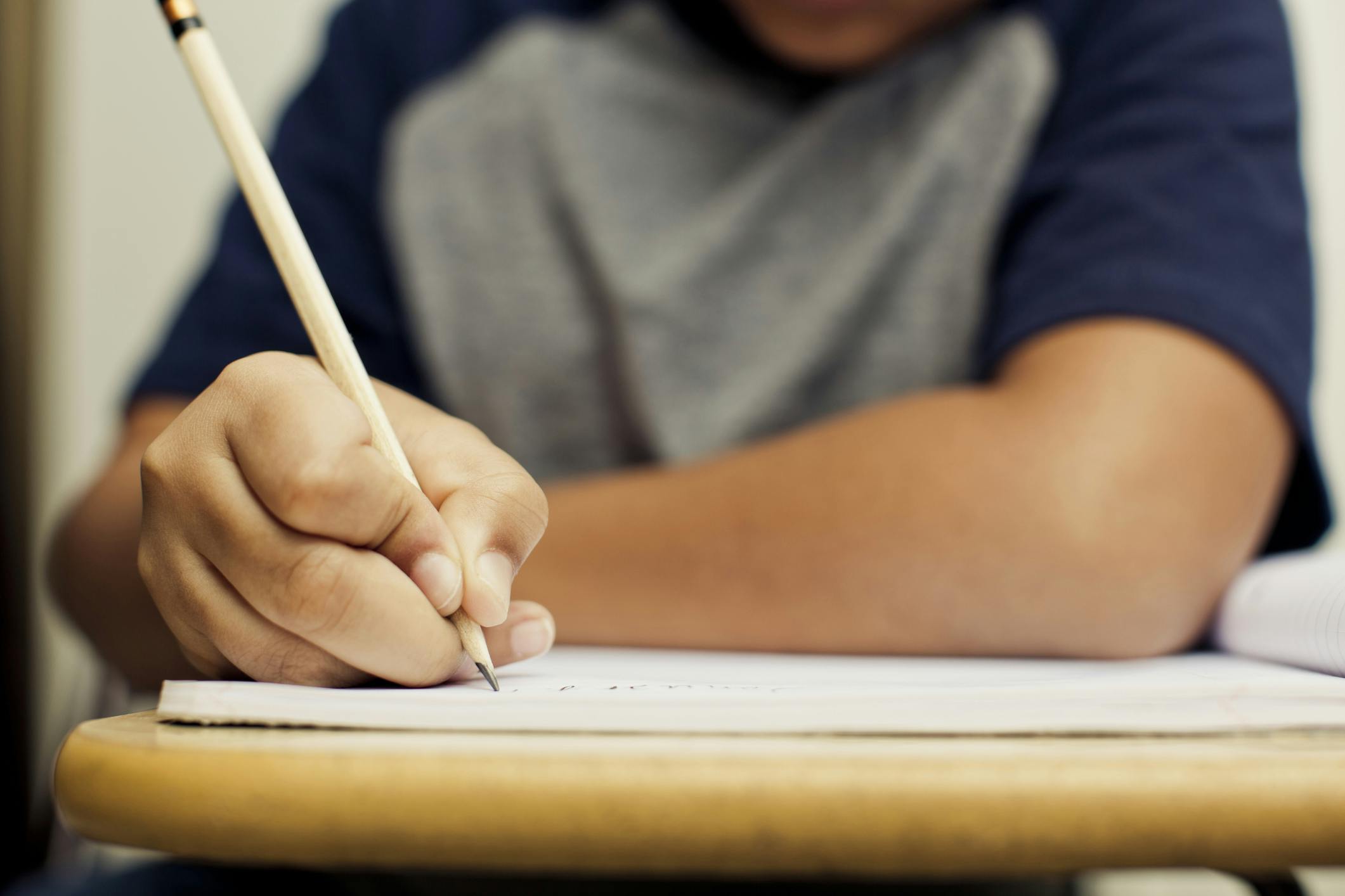 Zoomed in image of a student's hand writing in a journal