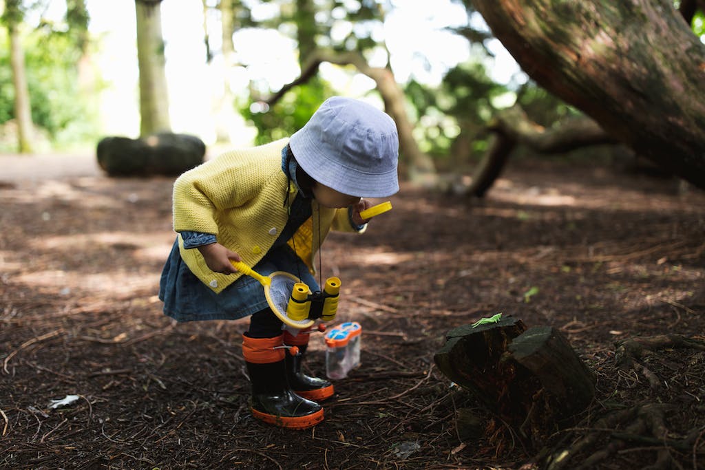 Unschooled child learning and exploring outside