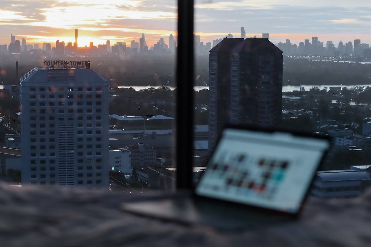 Blurred laptop screen with city skyline in background
