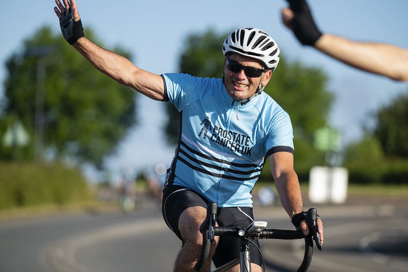 Man waving on bike
