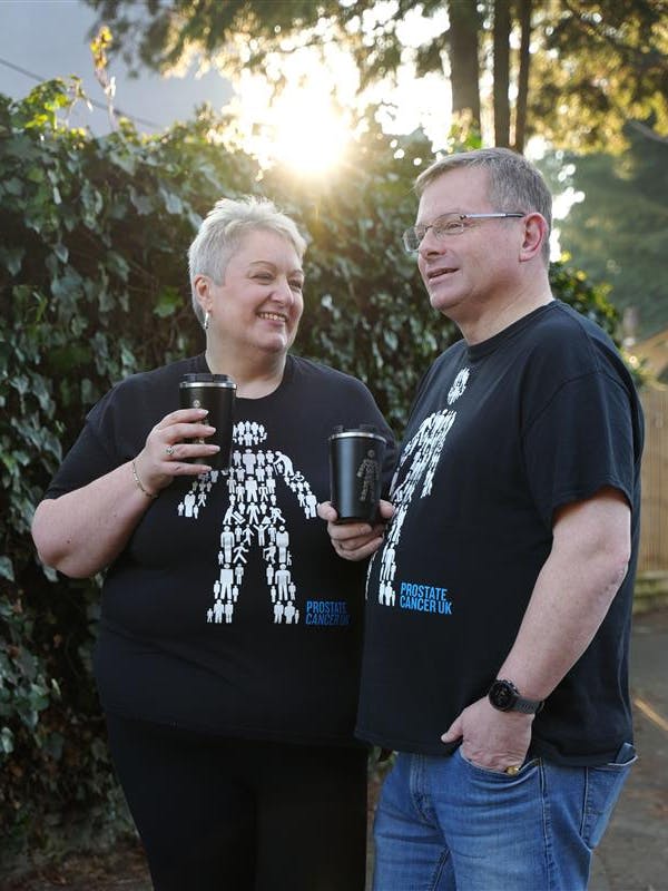 Man and woman wearing man of men t-shirts