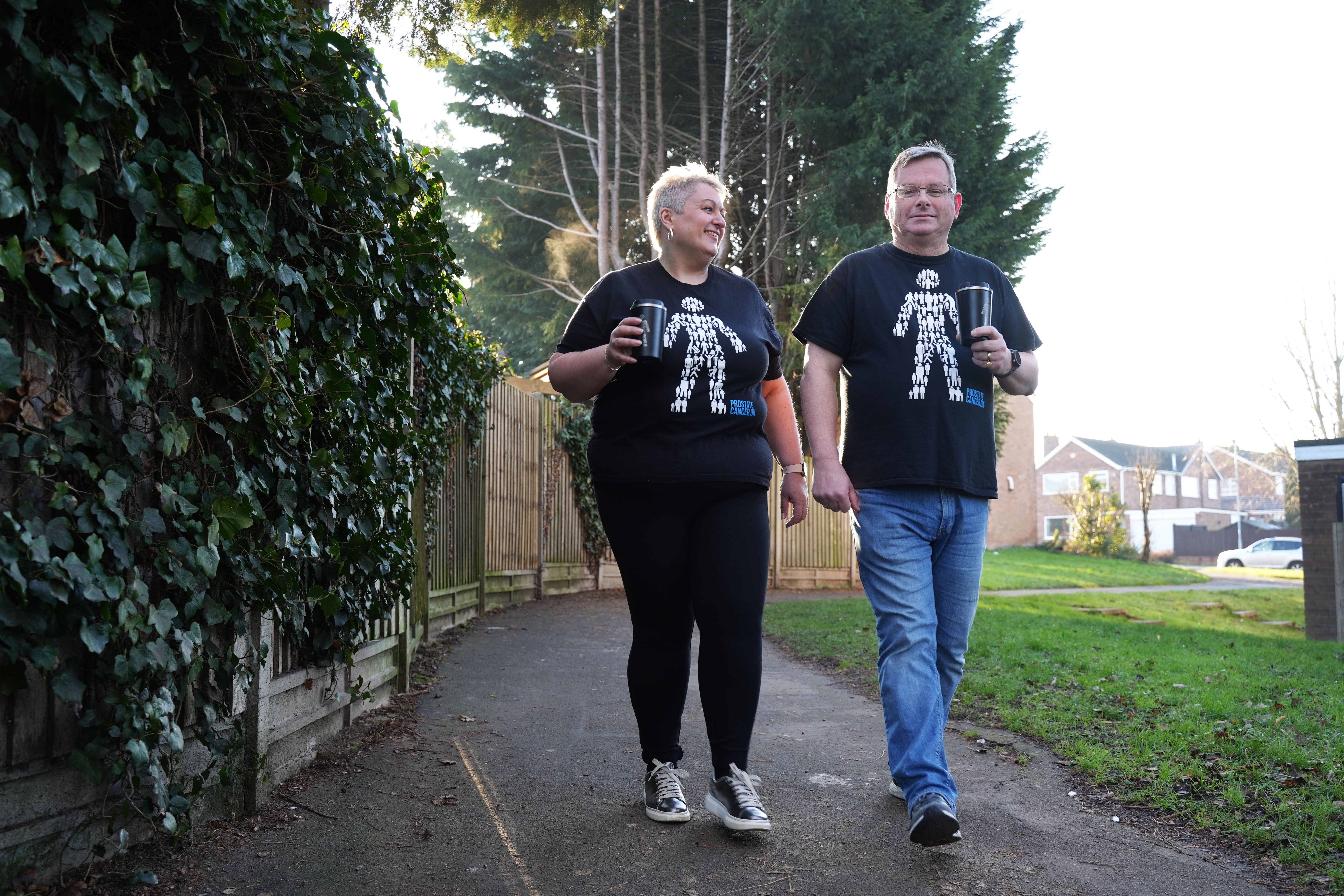 A man and woman wearing Man of Men t-shirts 