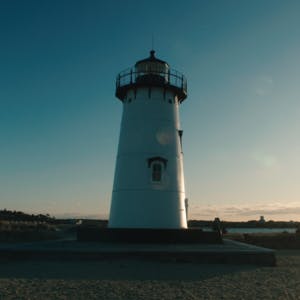 A picture of a lighthouse during sunset