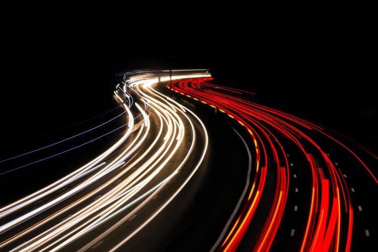 A long exposure picture cars on a highway at nighttime