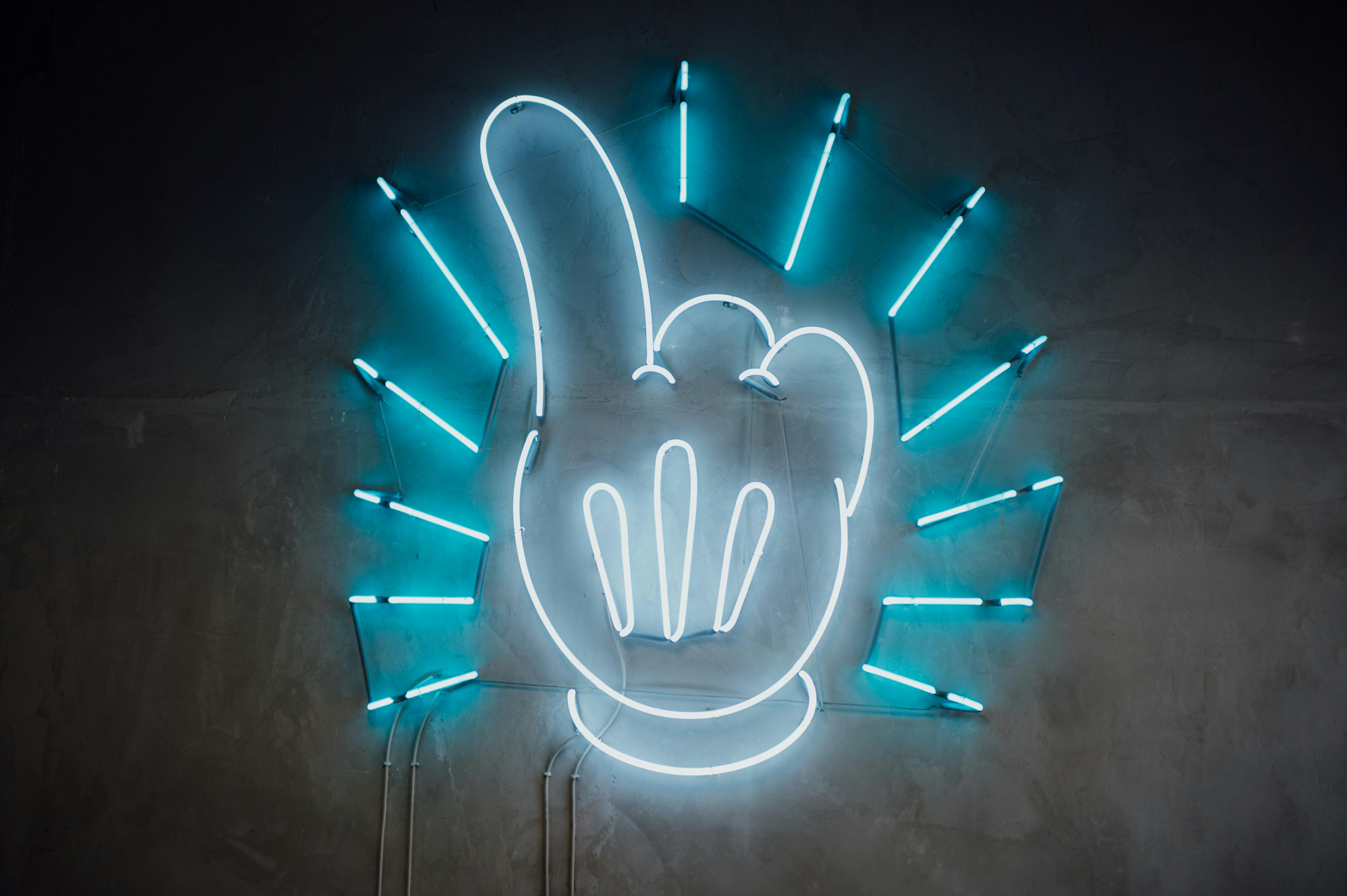 A hand shaped neon light with blue neon light accents