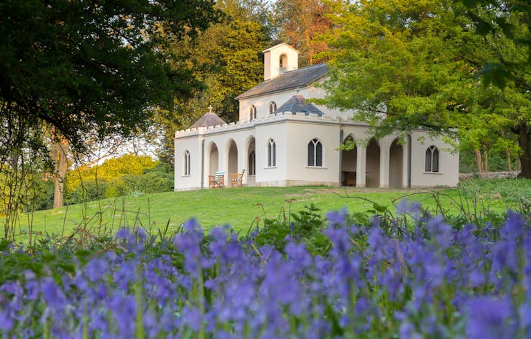 Cobham Dairy, Kent, surrounded by bluebells in the spring. Purcell undertook the conservation and repair of the old dairy, now a holiday home.