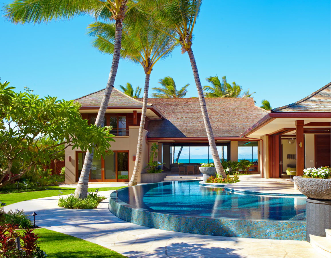 Exterior photo of house with pool and trees