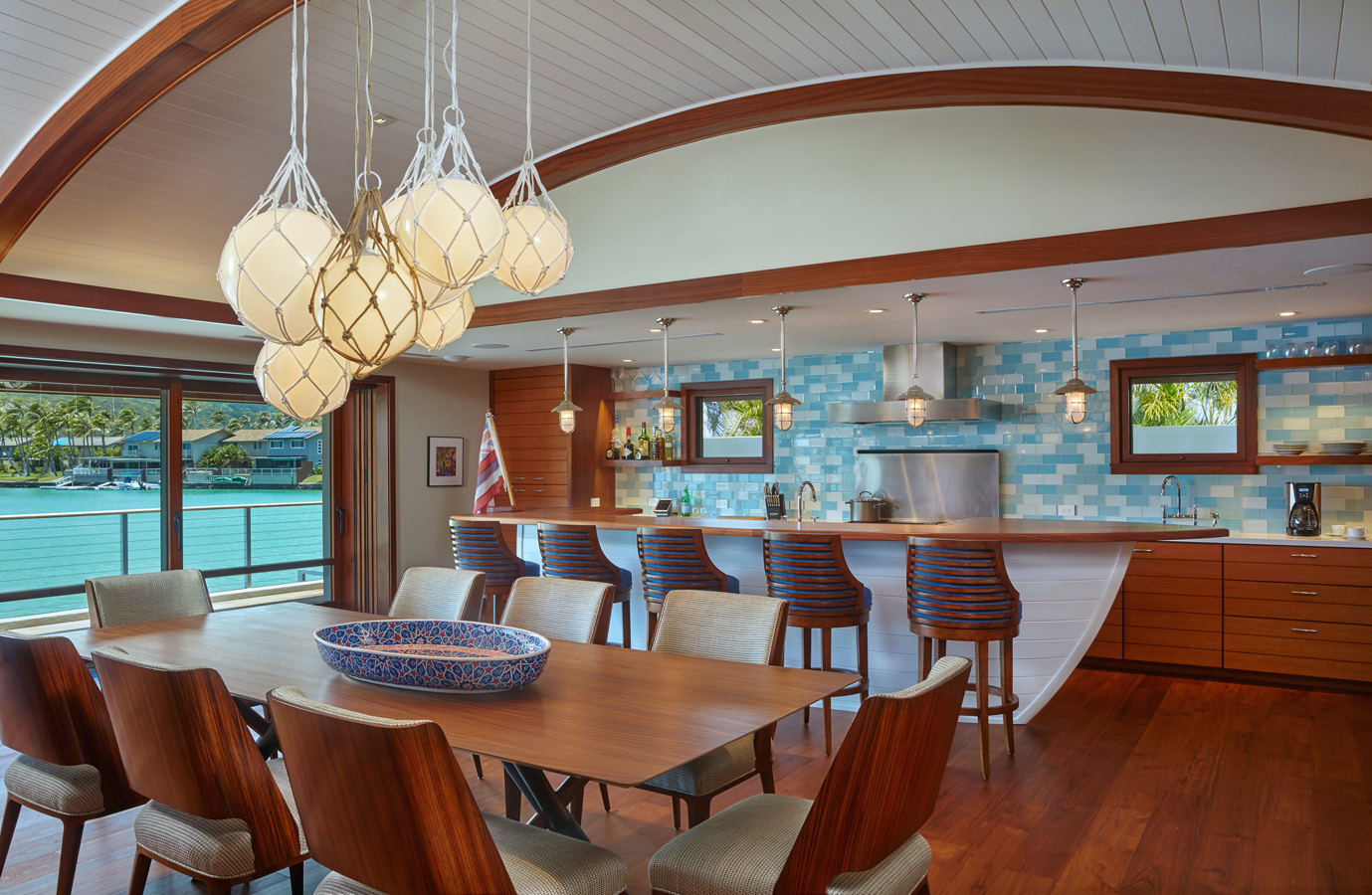 Dining room and kitchen with bar stools and ceiling light fixture
