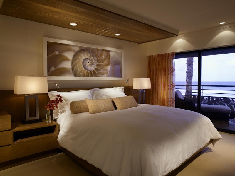 Bed in suite with art and furnishings.