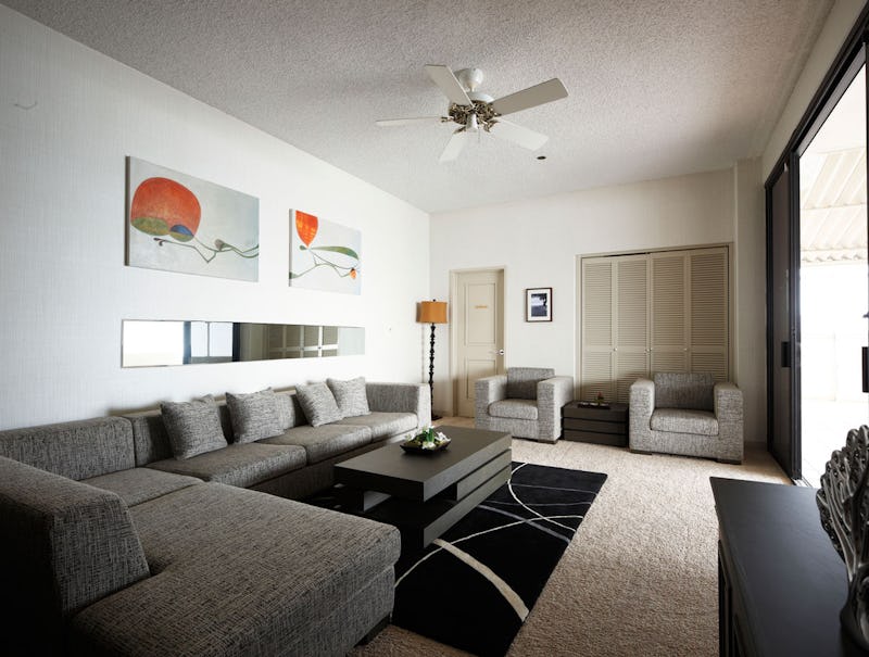 Room with gray couches and chairs with natural sunlight