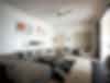 Room with gray couches and chairs with natural sunlight