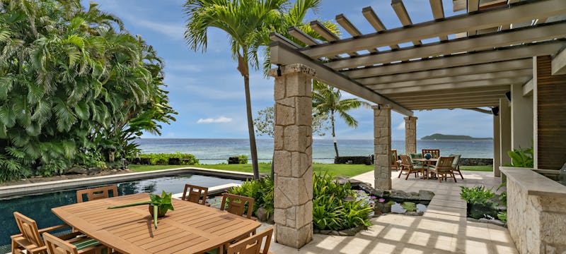 Outdoor photo of lounge area with ocean in view