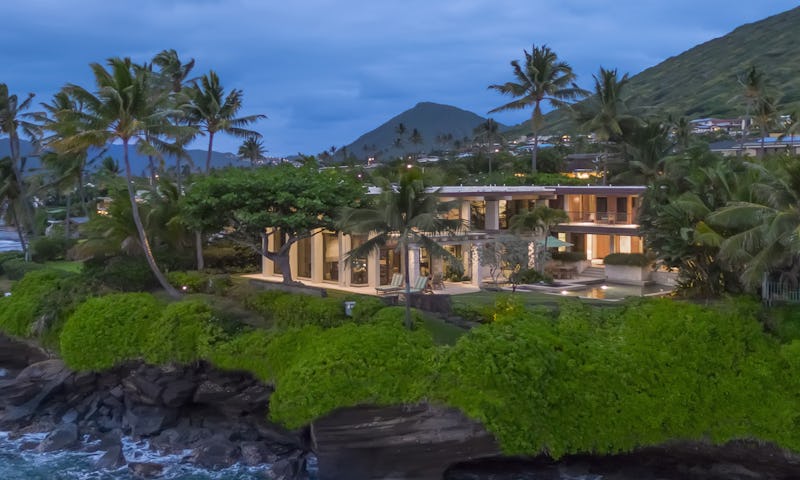 Exterior photo of oceanfront house with crashing ocean