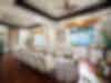 Upscale reception room with surfboards, paddles, and long table.