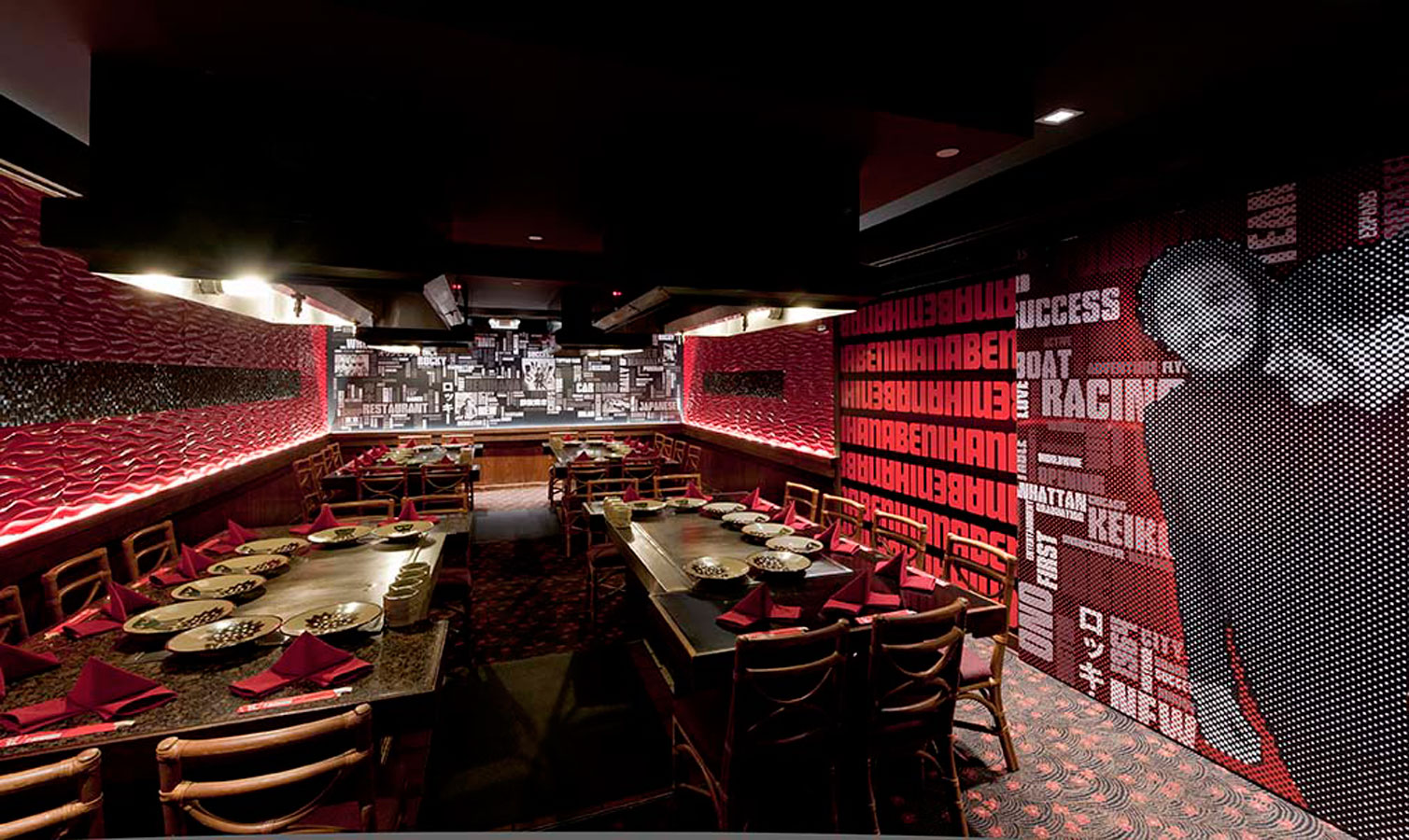Dining tables at Benihana of Tokyo at Hilton Hawaiian Village with typography-filled walls in the background