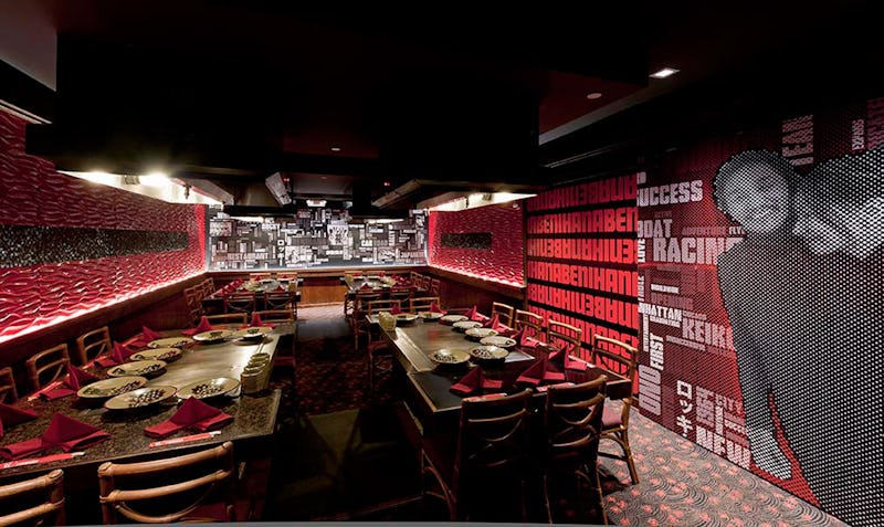 Dining tables at Benihana of Tokyo at Hilton Hawaiian Village with typography-filled walls in the background