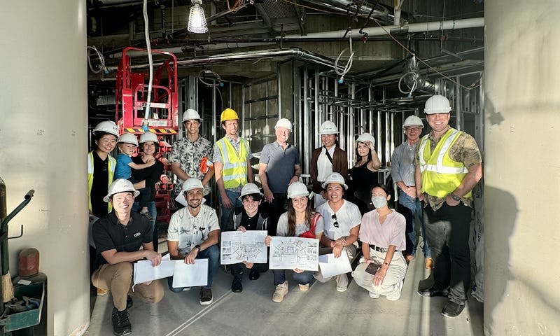 Tour group poses for a photo at the project construction site.