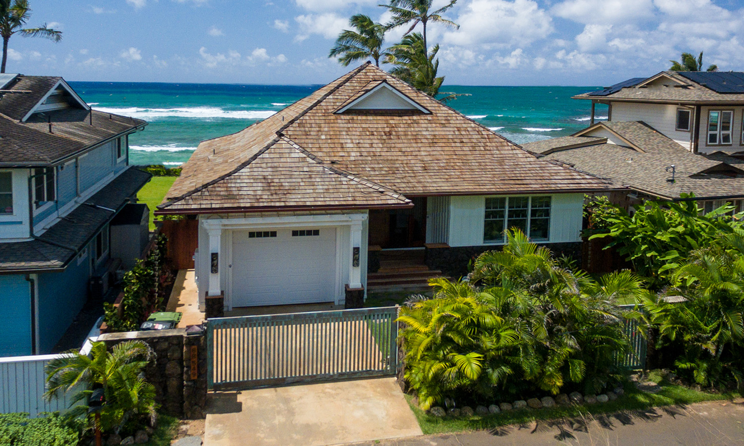 Exterior photo of house with ocean in the background