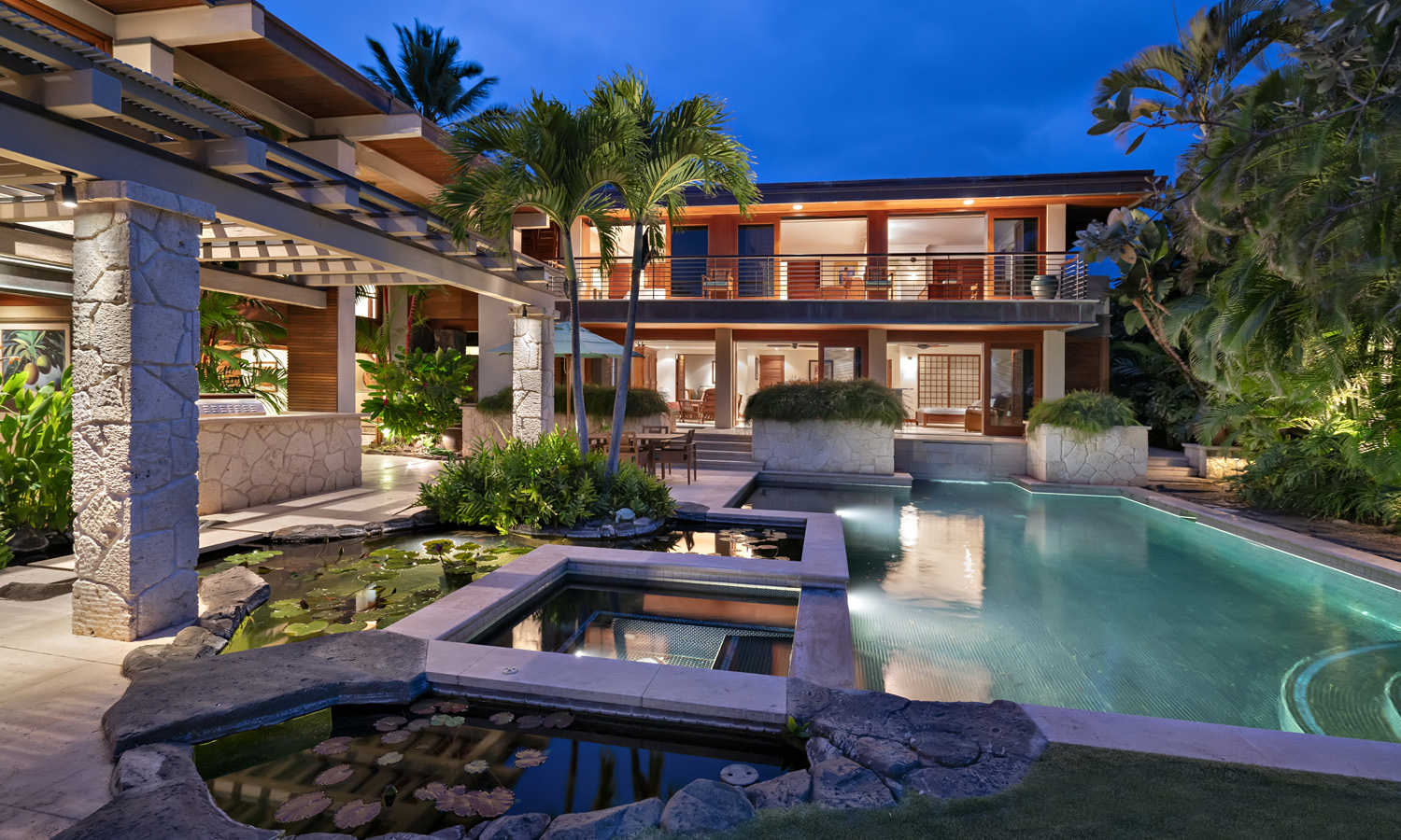 Exterior photo of house with pool and pond