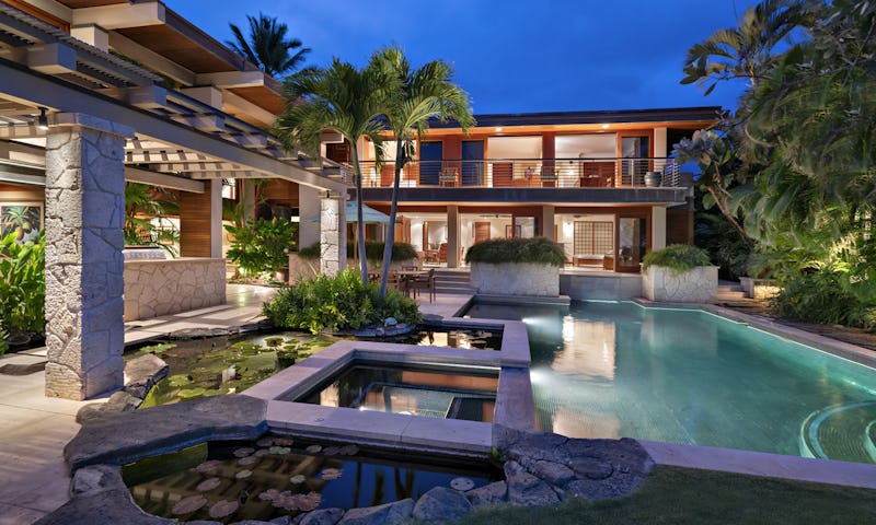 Exterior photo of house with pool and pond