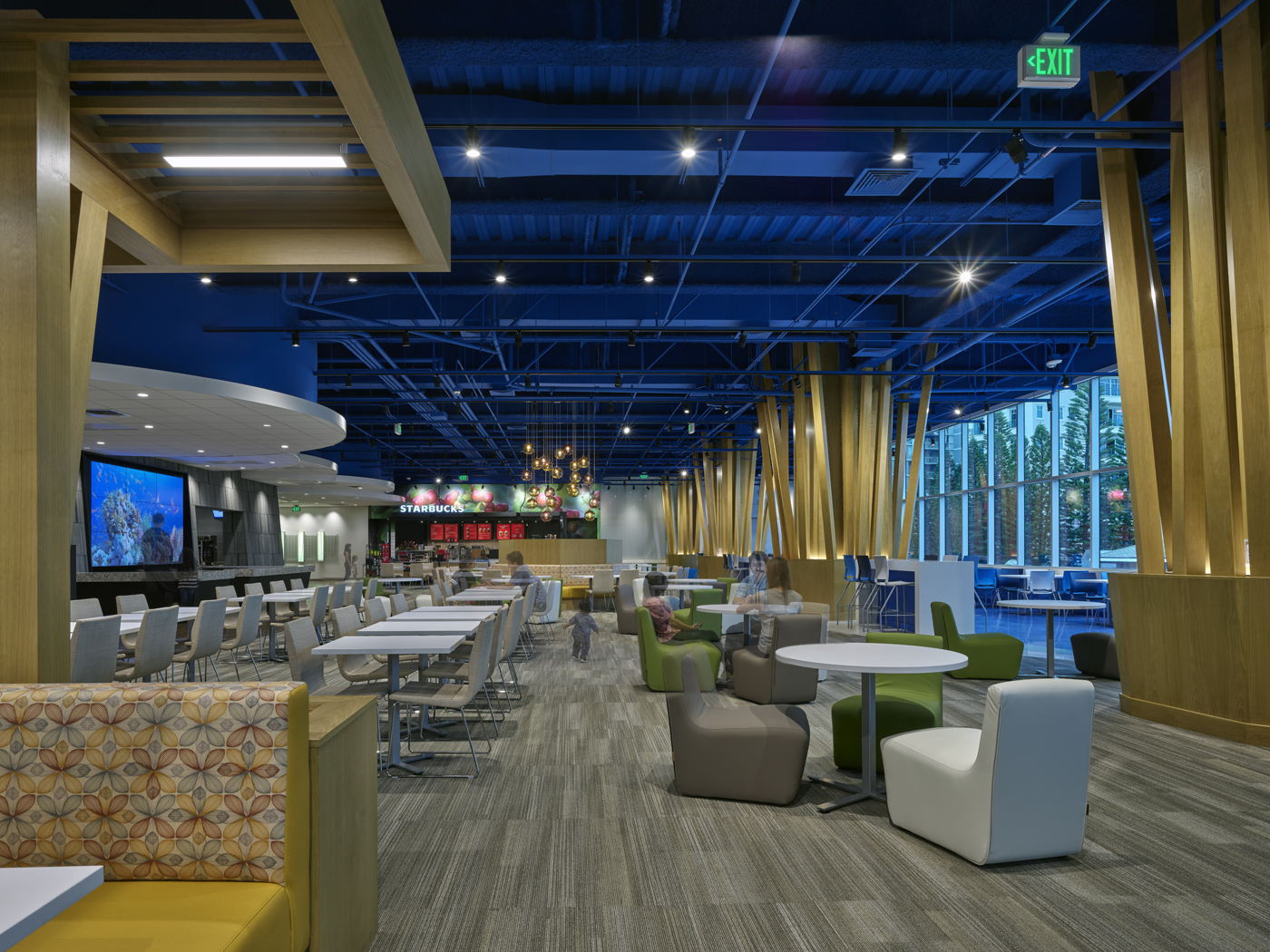 Looking backwards Starbucks with tables and chairs in the space