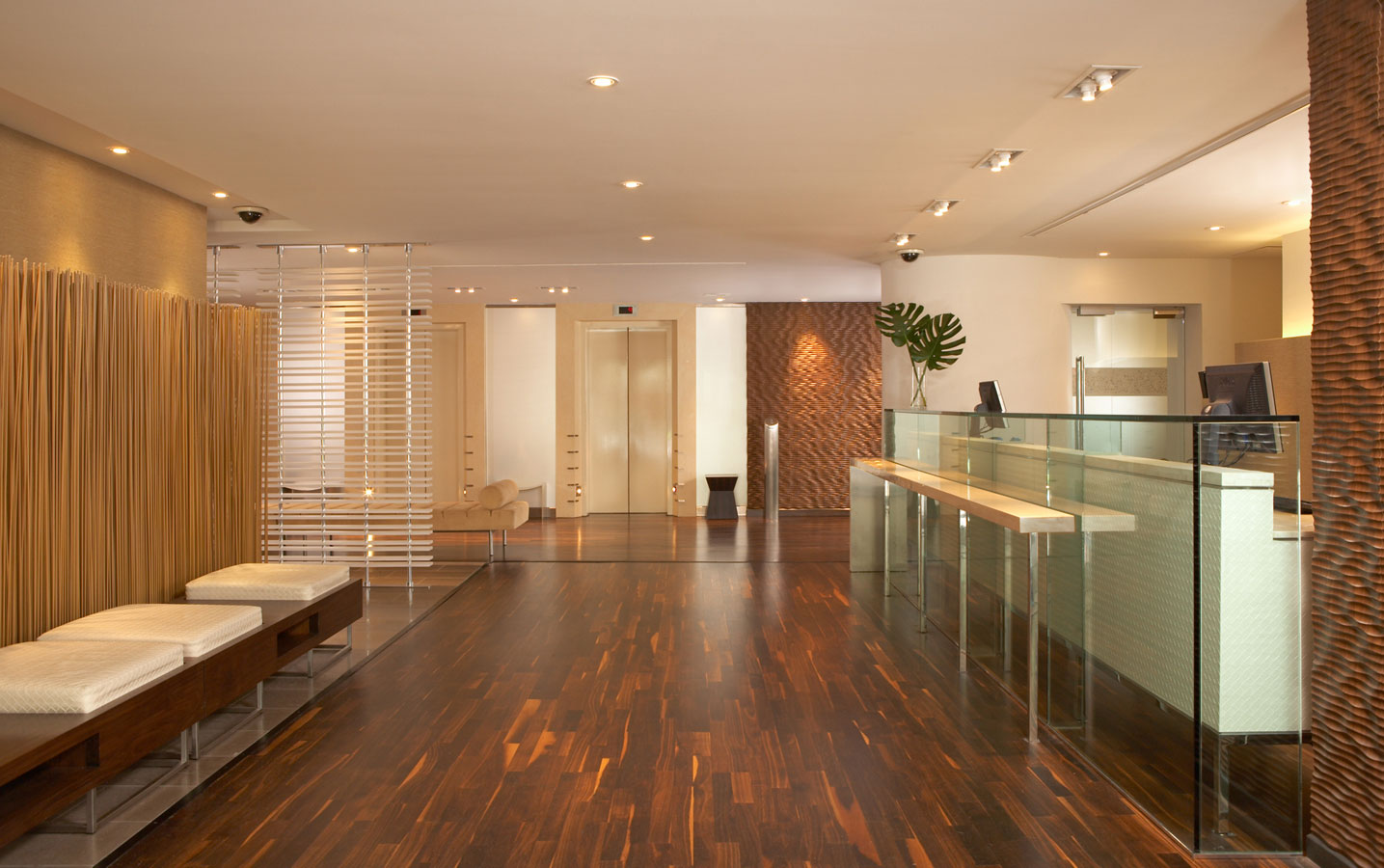 Wide shot of lobby area with elevators and seating area.