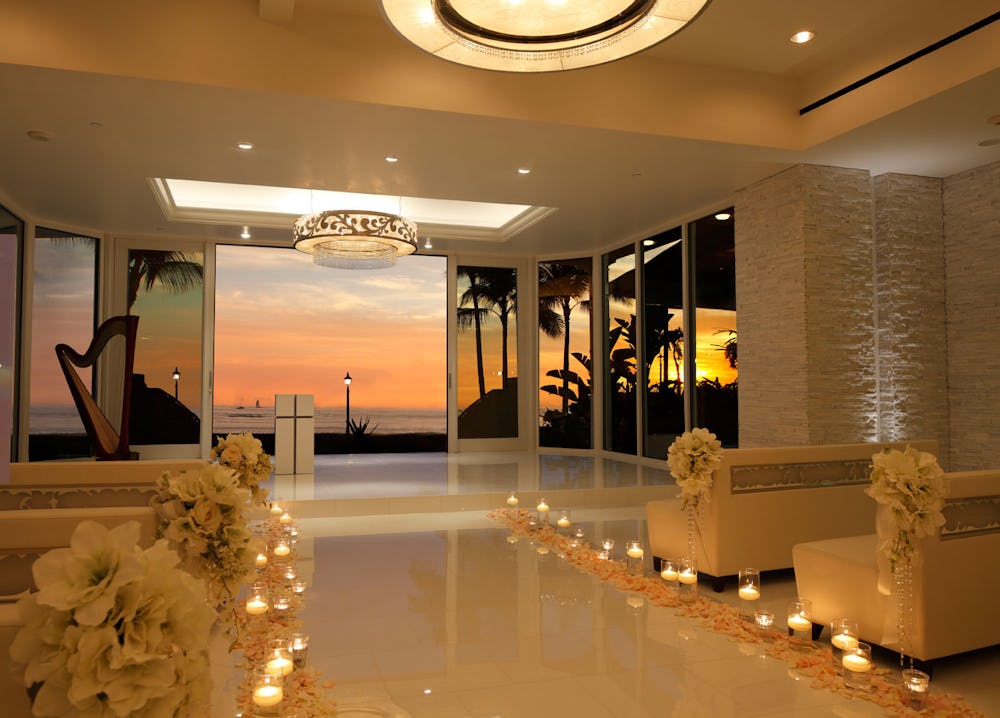 Chapel with flowers, candles, and view of a sunset.