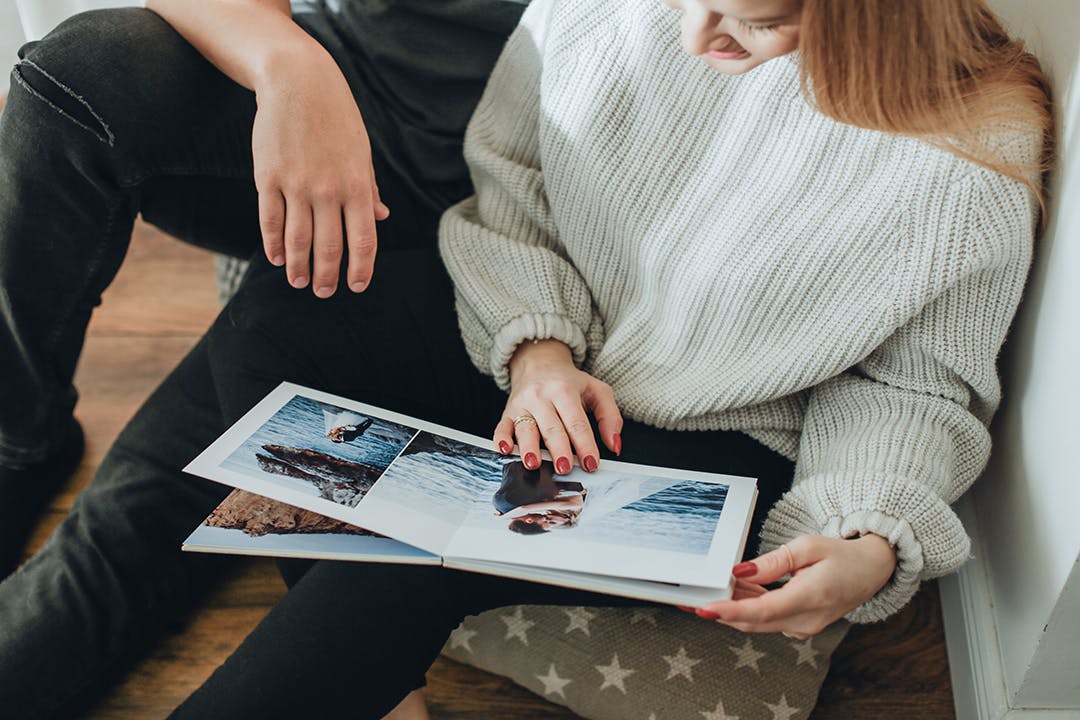 Referred photography clients looking at photo album