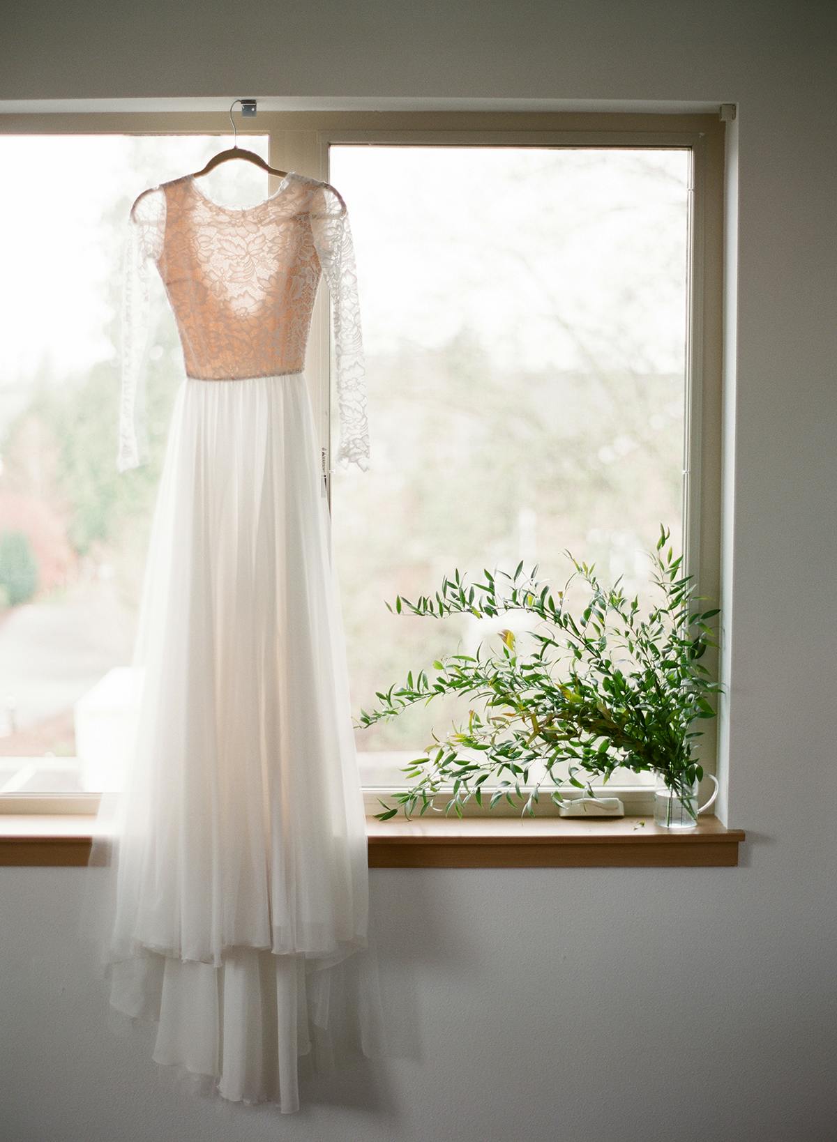Wedding film photography dress hanging in window