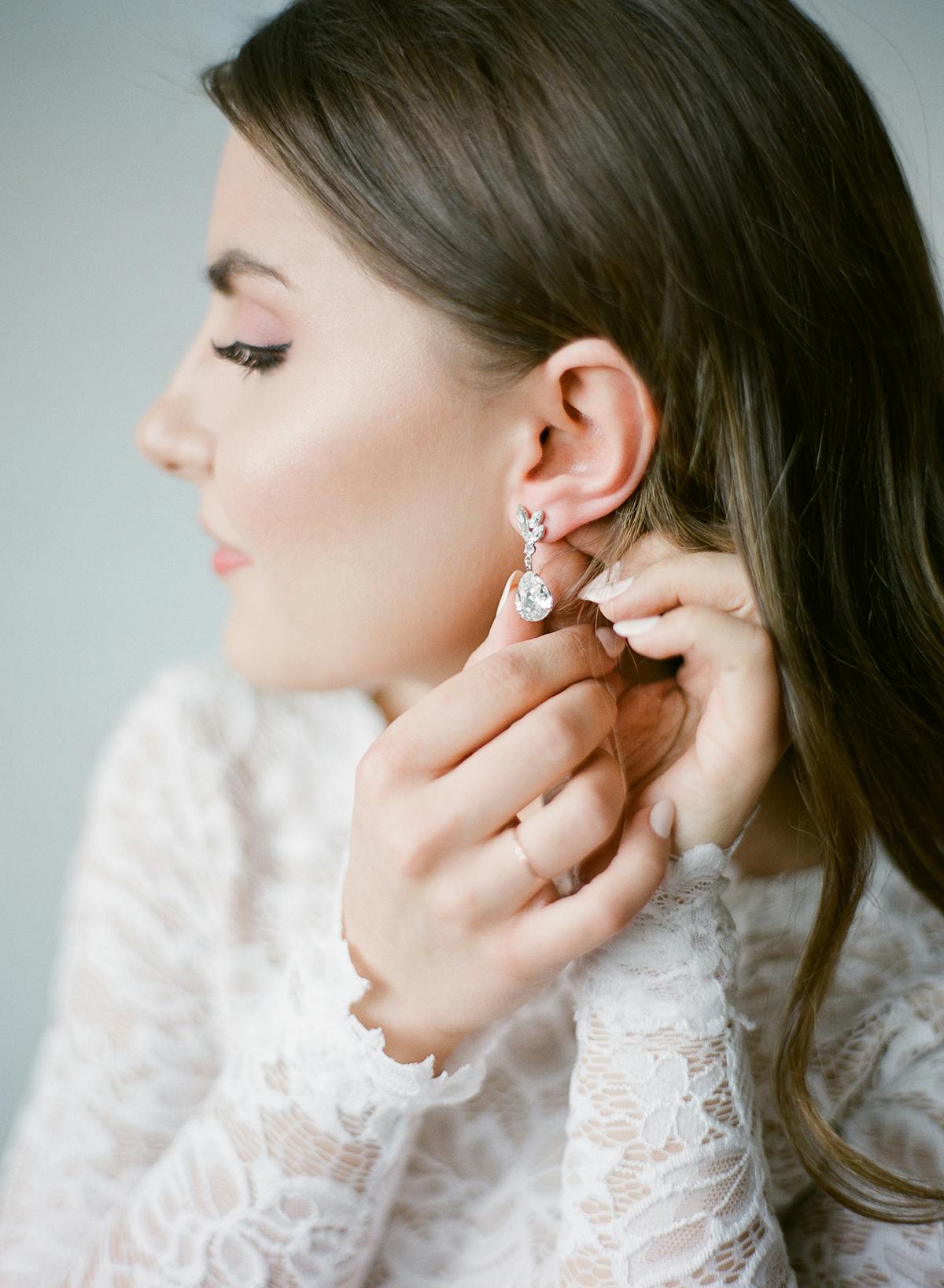 Film wedding photography by Daniel Usenko bride putting on earrings