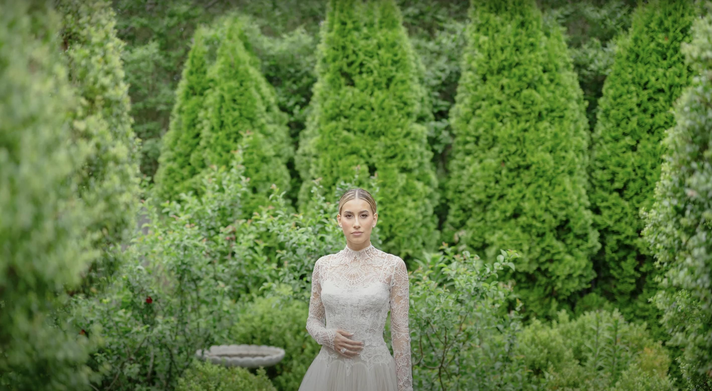 Adonye Jaja photograph of a bride in a lace dress against a backdrop of trees